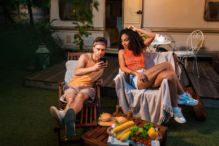 young couple on vacation with the camper. Traveling with the autocaravan. Concept about wanderlust...
