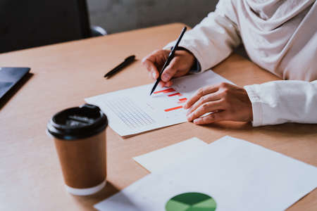 Beautiful middle-eastern businesswoman wearing hijab working in her officeの写真素材