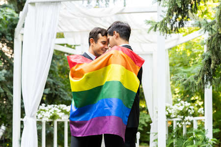 Homosexual couple celebrating their own wedding - LBGT couple at wedding ceremony, concepts about inclusiveness, LGBTQ community and social equityの写真素材