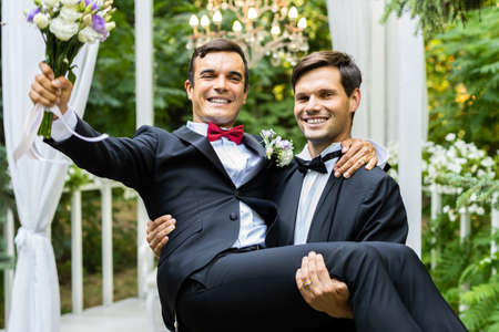 Homosexual couple celebrating their own wedding - LBGT couple at wedding ceremony, concepts about inclusiveness, LGBTQ community and social equityの写真素材