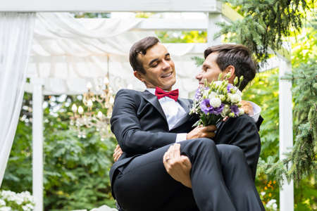 Homosexual couple celebrating their own wedding - LBGT couple at wedding ceremony, concepts about inclusiveness, LGBTQ community and social equityの写真素材