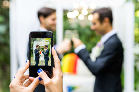 Homosexual couple celebrating their own wedding - LBGT couple at wedding ceremony, concepts about inclusiveness, LGBTQ community and social equityの写真素材