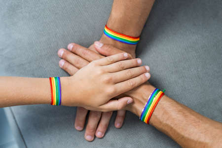 Lgbt family, gay couple with adopted son - Homosexual parents with their kid having fun at home