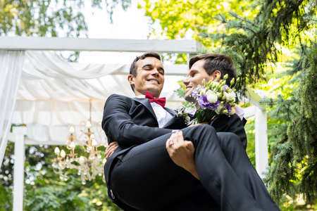 Homosexual couple celebrating their own wedding - LBGT couple at wedding ceremony, concepts about inclusiveness, LGBTQ community and social equityの写真素材