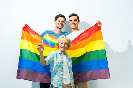 Lgbt family, gay couple with adopted son - Homosexual parents with their kid having fun at homeの写真素材