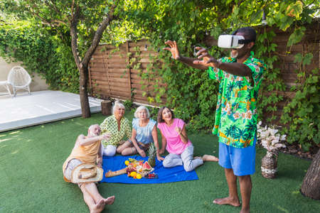 Beautiful senior friends relaxing at home in the garden - Elderly people rest in a peaceful backyard...