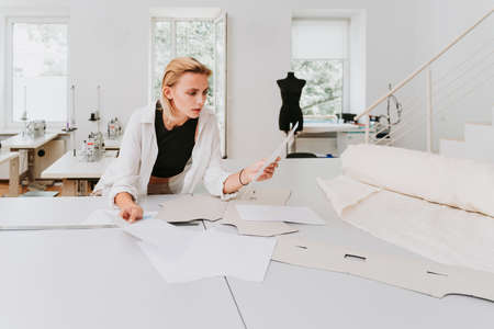 Fashion designer working in a clothing start-up workshop - Clothing tailor working on a new collectionの写真素材