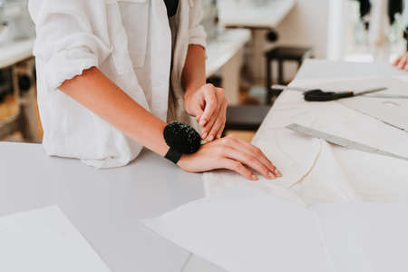 Multiethnic team of fashion designers working in a clothing start-up workshop - Multiracial group of...