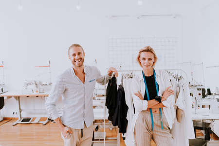 Multiethnic team of fashion designers working in a clothing start-up workshop - Multiracial group of...