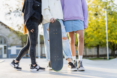 Multicultural group of young friends bonding outdoors and having fun - Stylish cool teens gathering at urban skate parkの写真素材