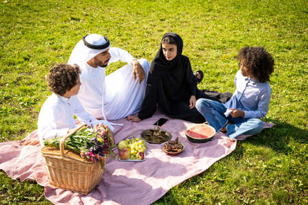 cinematic image of a family from the emirates spending time at the park