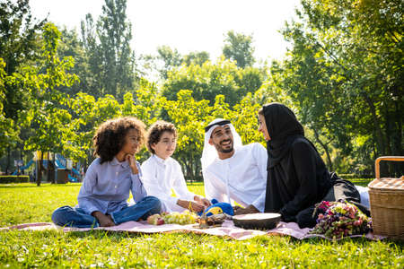 cinematic image of a family from the emirates spending time at the parkの写真素材
