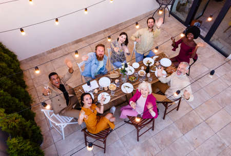 Storytelling footage of a multiethnic group of people dining on a rooftop. Family and friends make a...