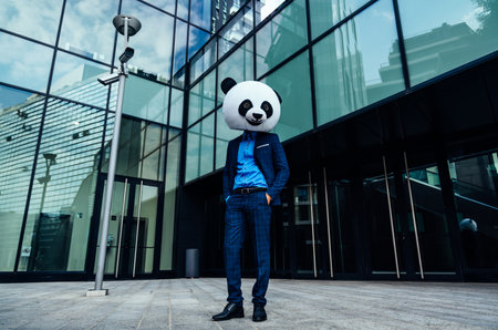 Storytelling image of a business man wearing a giant panda headの写真素材
