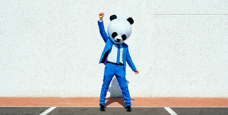 Man having fun wearing a funny colored mascot suitの写真素材