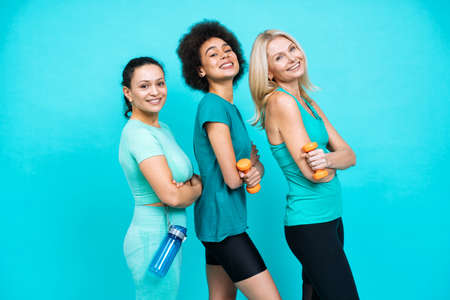 group of women with different body, age, and ethnicity making sport. Female models wearing sport outfits having fun at the gym. Concept about body positivity, self acceptance and lifestyleの写真素材