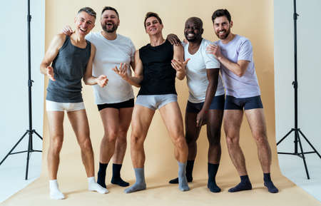 group of multiethnic men posing for a male edition body positive beauty set. guys with different age, and body wearing boxers underwearの写真素材