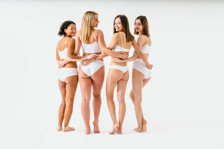 Portrait of multicultural group of women with diverse bodies celebrating self love and self acceptance, rear wiew - Beauty shot of multiethnic models, concepts about people, body postive, body acceptance and diversityの写真素材