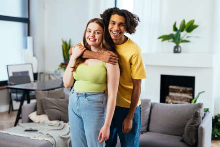 modern multiethnic unstereotyped couple lifestyle moments at home. Not stereotyped boyfriend and...