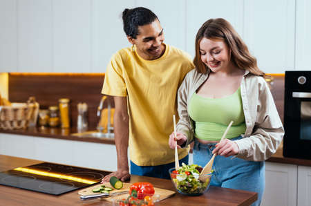 Modern multiethnic unstereotyped couple lifestyle moments at home. Not stereotyped boyfriend and girlfriend living together. True love conceptsの写真素材