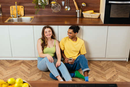 modern multiethnic unstereotyped couple lifestyle moments at home. Not stereotyped boyfriend and girlfriend living together. True love conceptsの写真素材