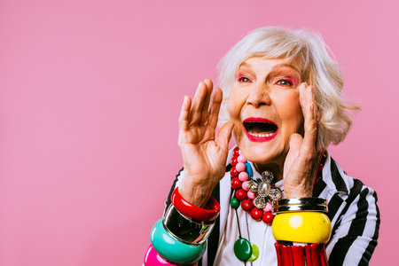 Happy and funny cool old lady with fashionable clothes portrait on colored background - Youthful...