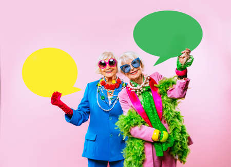 Happy and funny cool old ladies with fashionable clothes portrait on colored background - Youthful...