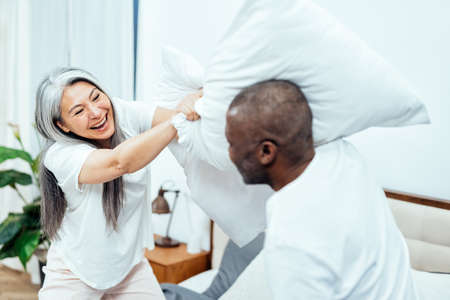 Cinematic image of a senior woman with silver head using the laptop computer and working from homeの写真素材