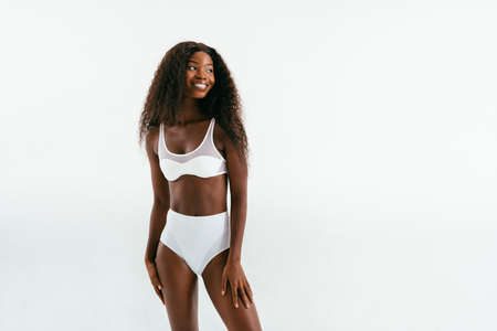 Beauty portrait of beautiful black woman wearing lingerie underwear - Pretty african young woman posing in studio, concepts about beauty, cosmetology and diversityの写真素材