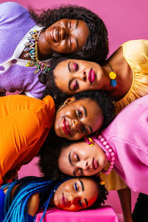 Beauty portrait of beautiful black women wearing colorful stylish clothes - Pretty african young women posing in studio, concepts about beauty, cosmetology and diversityの写真素材