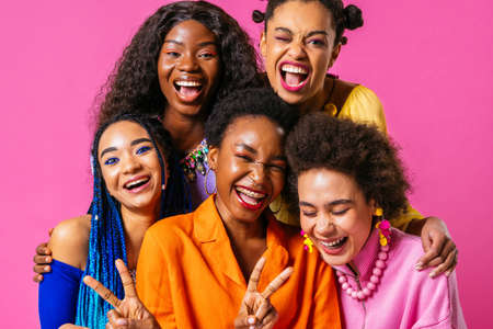 Beauty portrait of beautiful black women wearing colorful stylish clothes - Pretty african young women posing in studio, concepts about beauty, cosmetology and diversityの写真素材