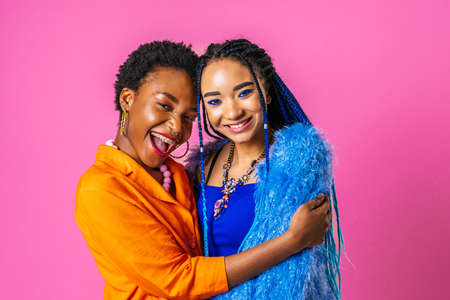 Beauty portrait of beautiful black women wearing colorful stylish clothes - Pretty african young women posing in studio, concepts about beauty, cosmetology and diversityの写真素材