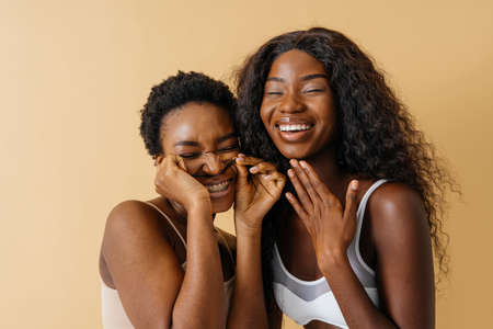 Beauty portrait of beautiful black women wearing lingerie underwear - Pretty african young women posing in studio, concepts about beauty, cosmetology and diversityの写真素材