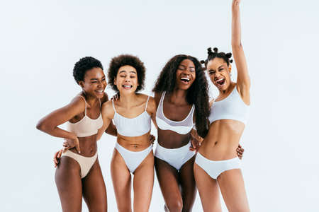Beauty portrait of beautiful black women wearing lingerie underwear - Pretty african young women posing in studio, concepts about beauty, cosmetology and diversityの写真素材