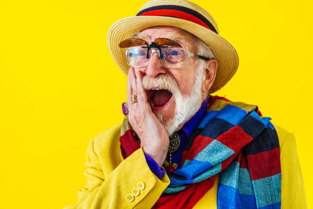 Cool senior man with fashionable clothing style portrait on colored background - Funny old male pensioner with eccentric style having funの写真素材