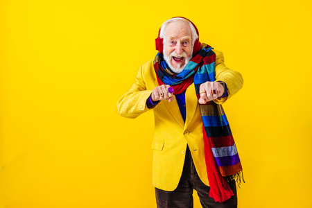 Cool senior man with fashionable clothing style portrait on colored background - Funny old male pensioner with eccentric style having funの写真素材