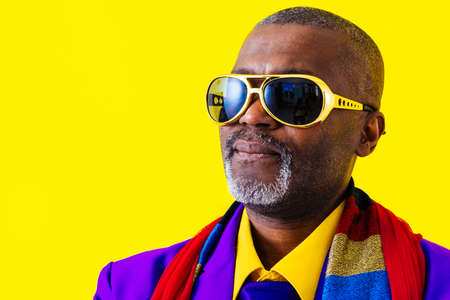 Cool senior man with fashionable clothing style portrait on colored background - Funny old male pensioner with eccentric style having funの写真素材