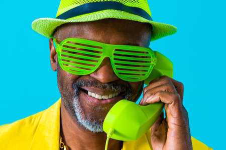 Cool senior man with fashionable clothing style portrait on colored background - Funny old male pensioner with eccentric style having funの写真素材