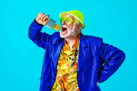 Cool senior man with fashionable clothing style portrait on colored background - Funny old male pensioner with eccentric style having funの写真素材
