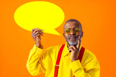 Cool senior man with fashionable clothing style portrait on colored background - Funny old male...