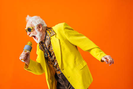 Cool senior man with fashionable clothing style portrait on colored background - Funny old male pensioner with eccentric style having funの写真素材