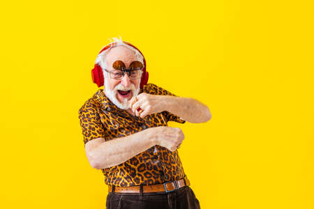 Cool senior man with fashionable clothing style portrait on colored background - Funny old male...