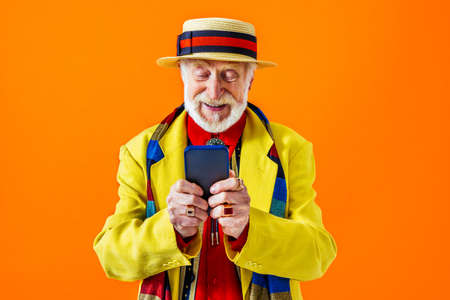 Cool senior man with fashionable clothing style portrait on colored background - Funny old male pensioner with eccentric style having funの写真素材