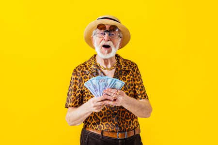 Cool senior man with fashionable clothing style portrait on colored background - Funny old male pensioner with eccentric style having funの写真素材