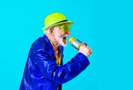 Cool senior man with fashionable clothing style portrait on colored background - Funny old male pensioner with eccentric style having funの写真素材