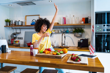 Beautiful latino young woman at home - Pretty south american with curly hair female portrait, lifestyle and domestic life sceneの写真素材