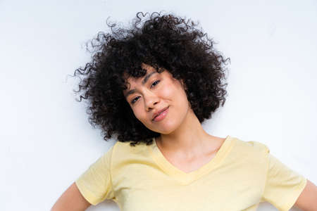 Beautiful latino young woman at home - Pretty south american with curly hair female portrait,...