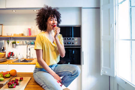 Beautiful latino young woman at home - Pretty south american with curly hair female portrait,...
