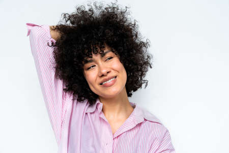 Beautiful latino young woman at home - Pretty south american with curly hair female portrait,...