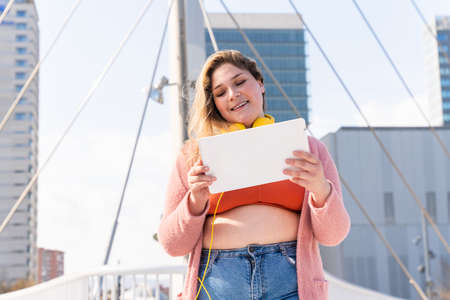 Beautiful and cheerful plus size young woman outdoors - Pretty overweight curvy female, concepts about femininity, women power, female emancipation, body positivity and body acceptanceの写真素材